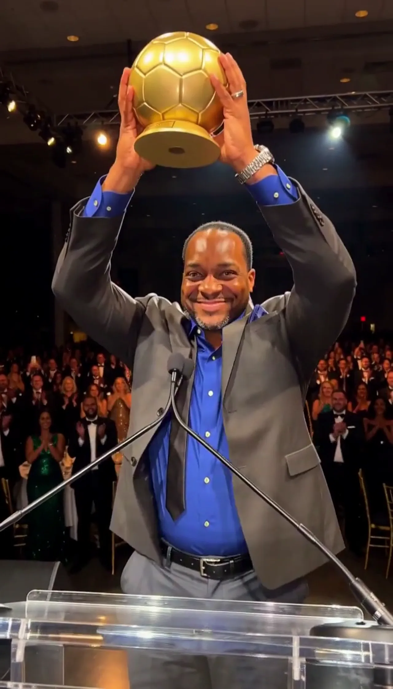 A Grin Before He Reaches the Mic